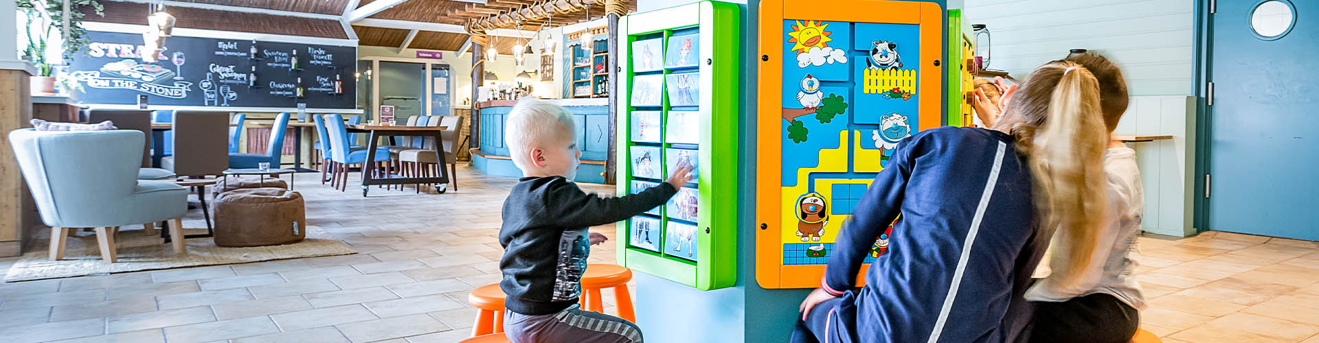 this image shows a kids corner with wallgames in a restaurant